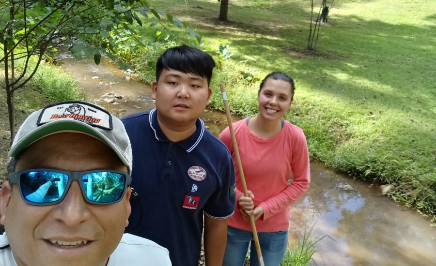 From left, Dr. Adrian Vasquez with Mercer University students Andy Yin and Bryce Williams after a day in the field collecting aquatic organisms.