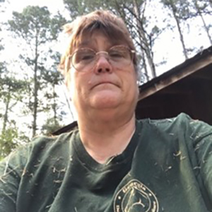 Picture of Rosmarie Kelly, PhD MPH outdoors wearing a dark green volunteer T‑shirt.